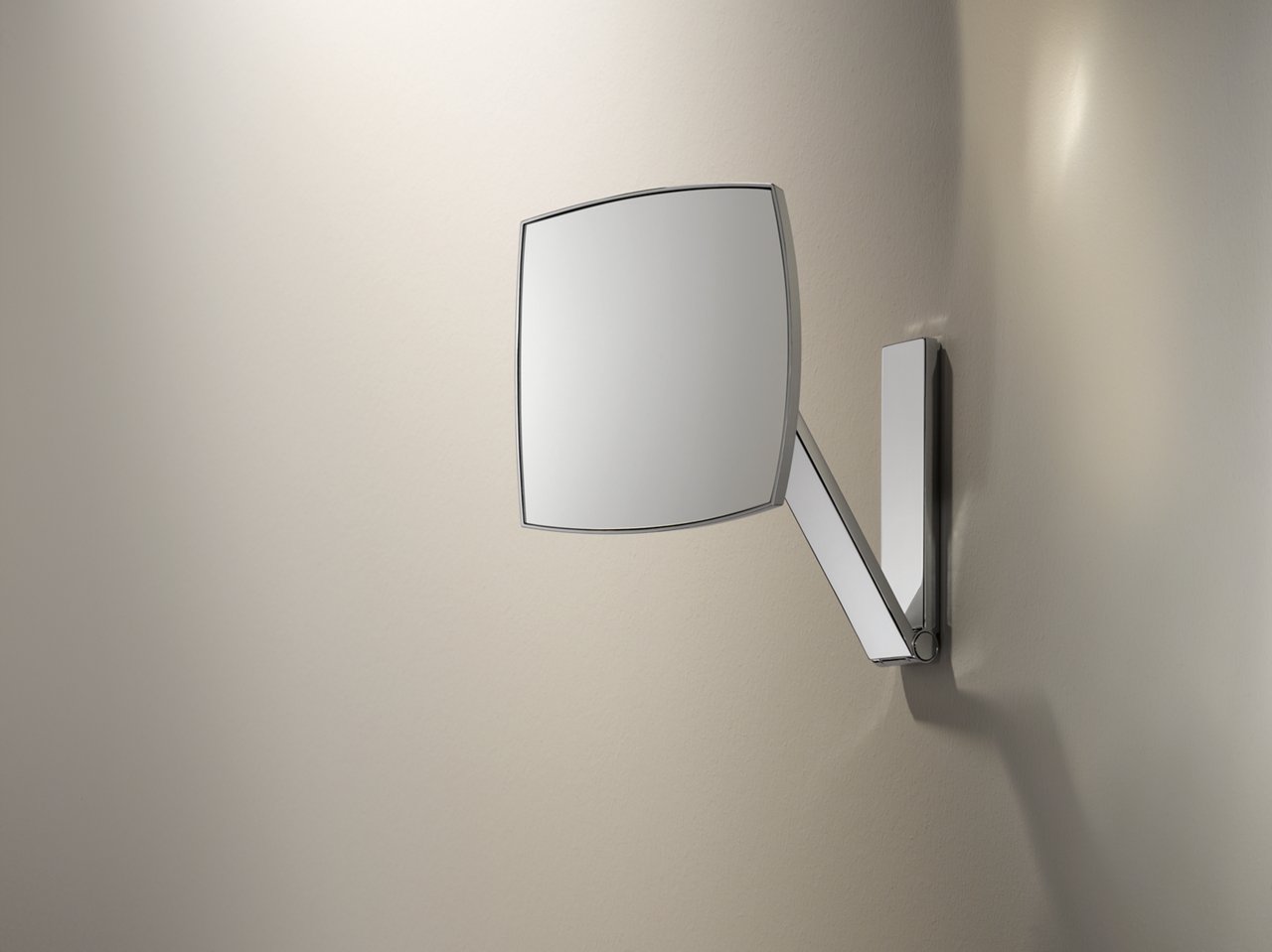 The square, unlit iLook_move cosmetic mirror is mounted on the wall