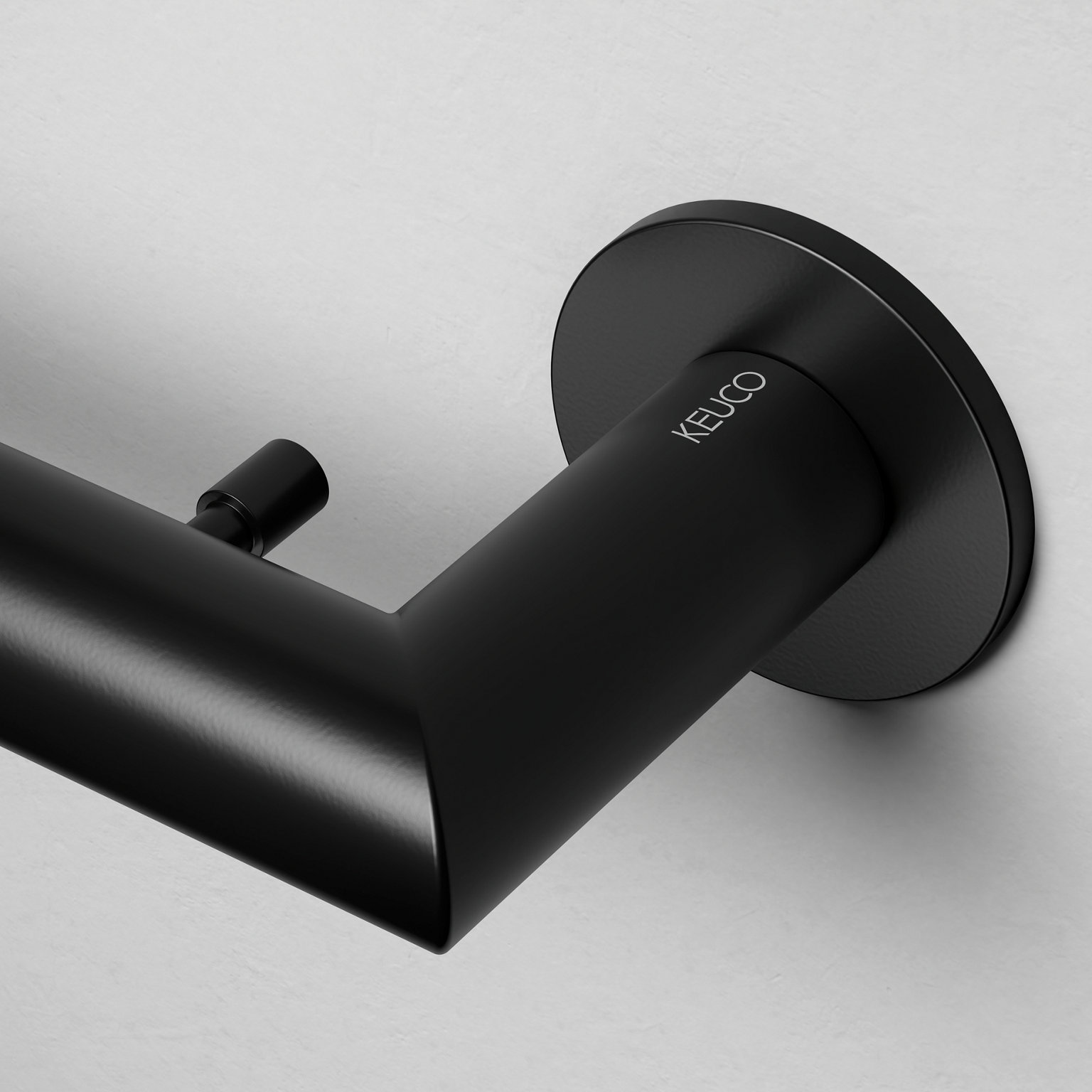 Detailed view of the bath towel rail and adhesive fastening in black with KEUCO logo